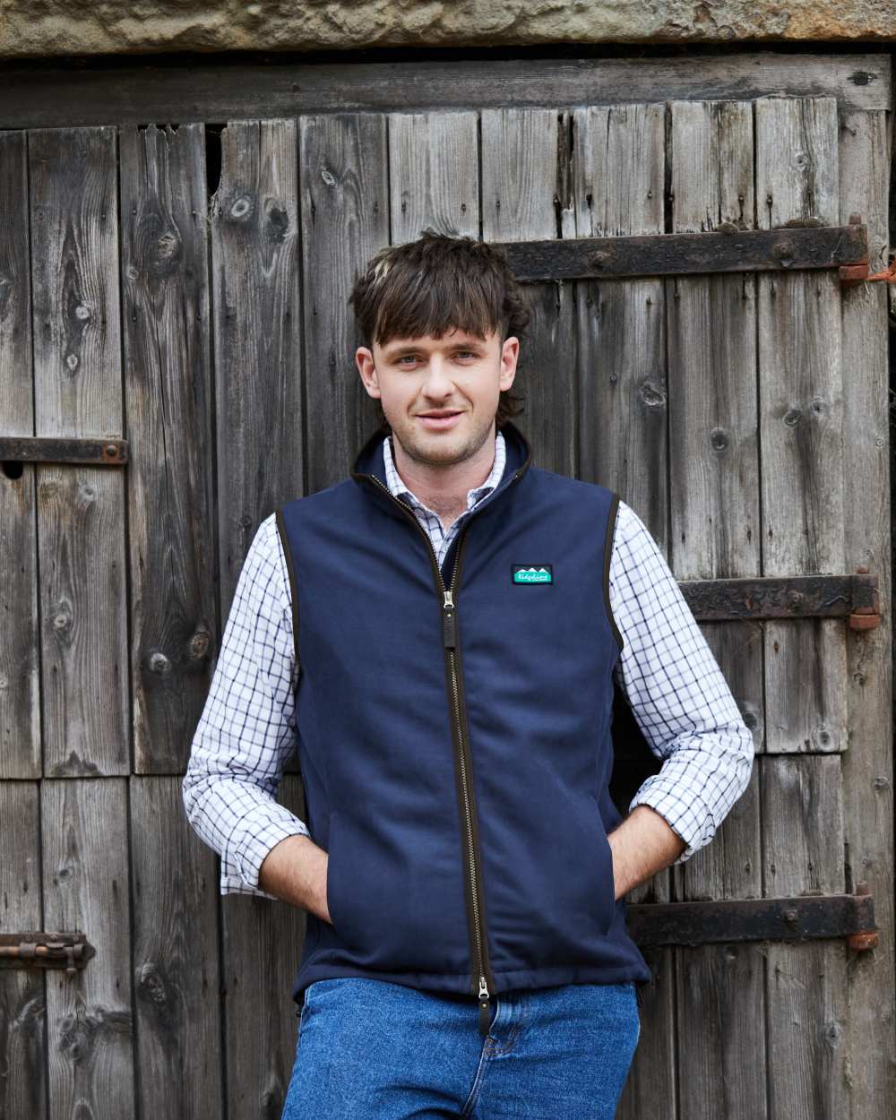 Navy coloured Ridgeline Mens Monarch Gilet on door background