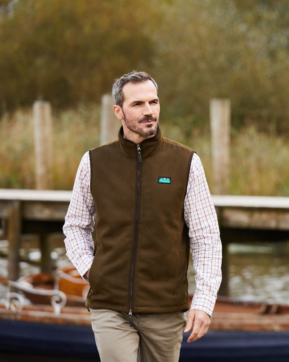 Teak coloured Ridgeline Mens Monarch Gilet on backwater background