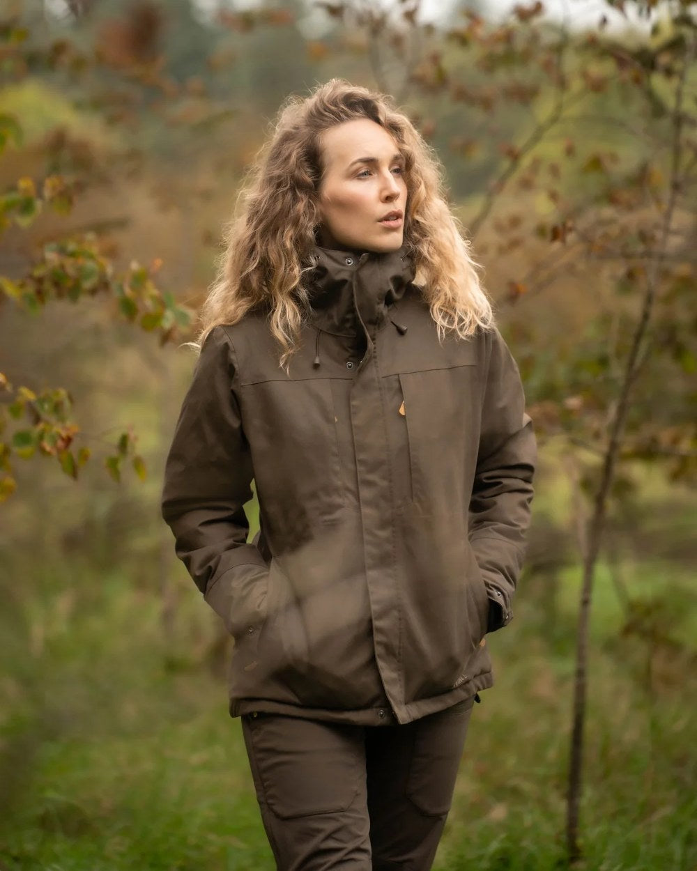 Olive Green Rovince Womens Ergoline Jacket on blurry background