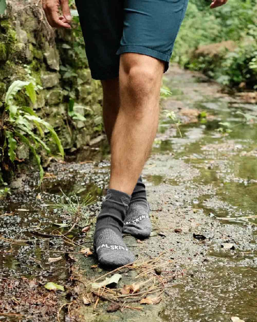 Black Coloured Sealskinz Raynham Waterproof All Weather Mid Length Sock on outdoor background
