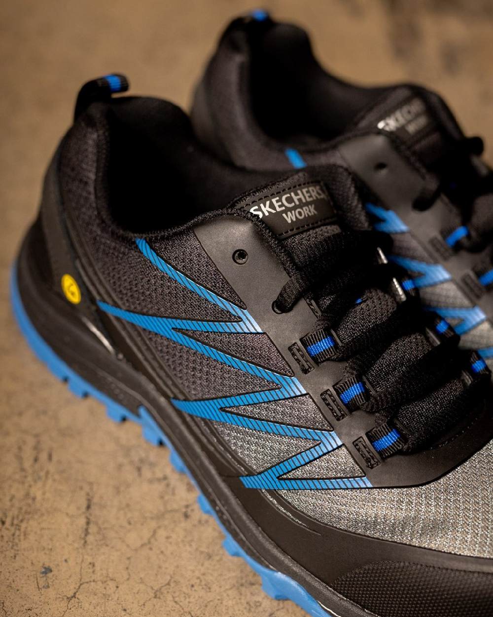 Black Blue Coloured Skechers Workwear Mens Puxal Safety Trainers on indoor background
