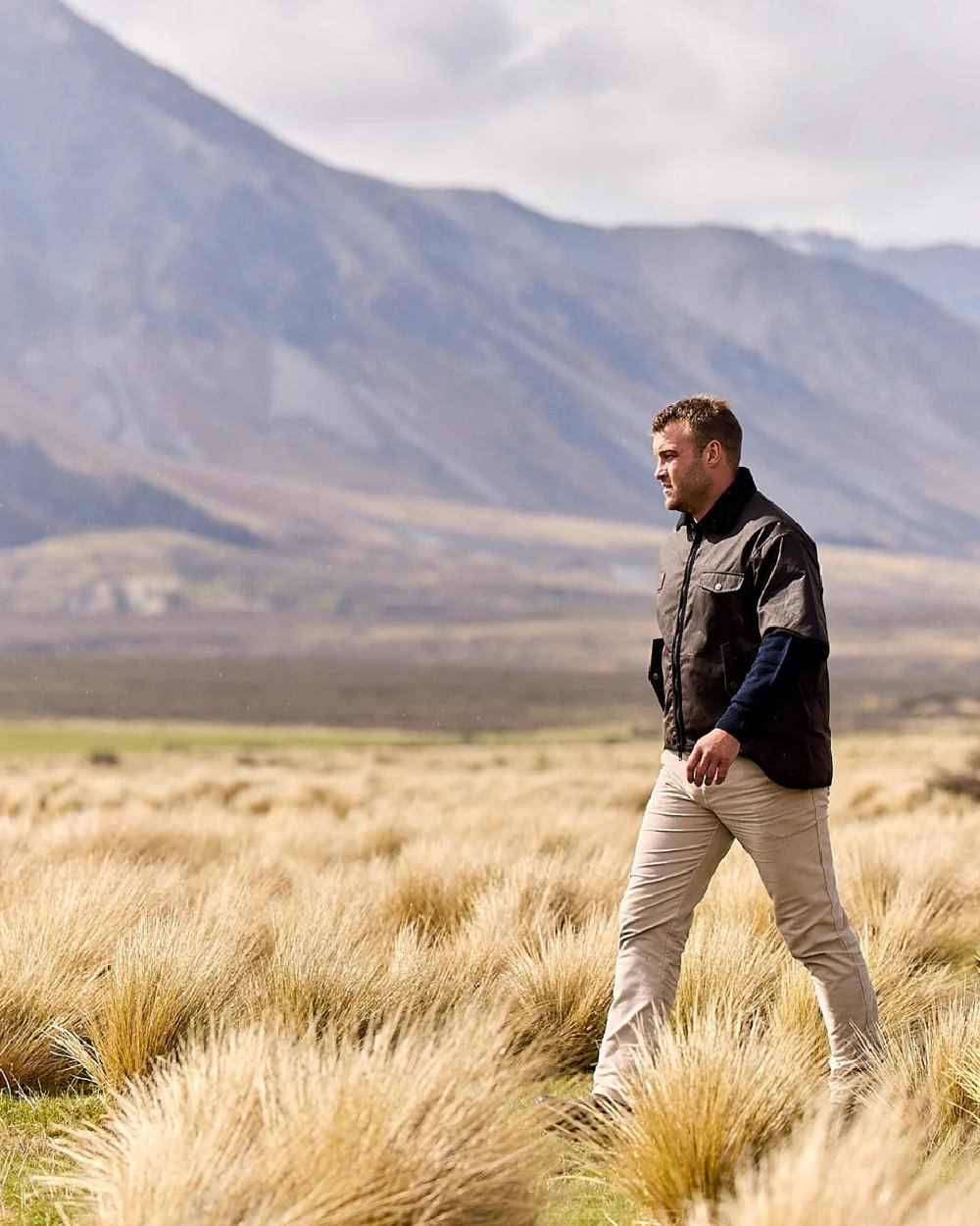 Brown Coloured Swanndri Mens 3/4 Sleeve Oilskin Jacket on field background