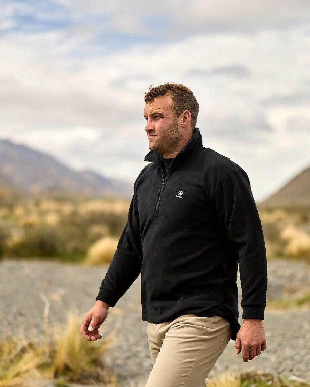 Black Coloured Swanndri Mens Motu Fleece Pullover on blurry background