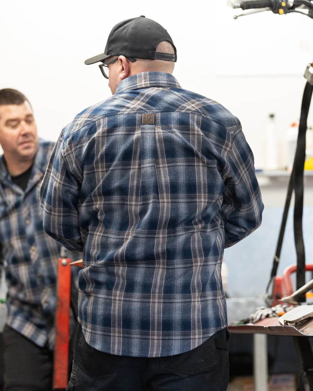 Navy coloured Swazi Grafter Shirt on blurry background
