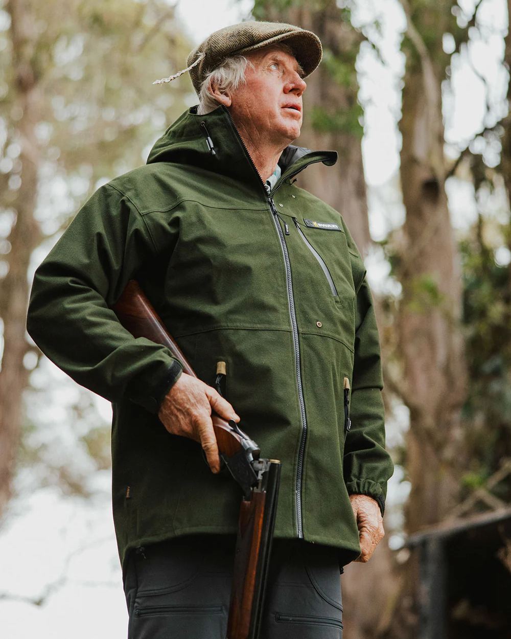 Olive coloured Swazi The Ibex Jacket on blurry background