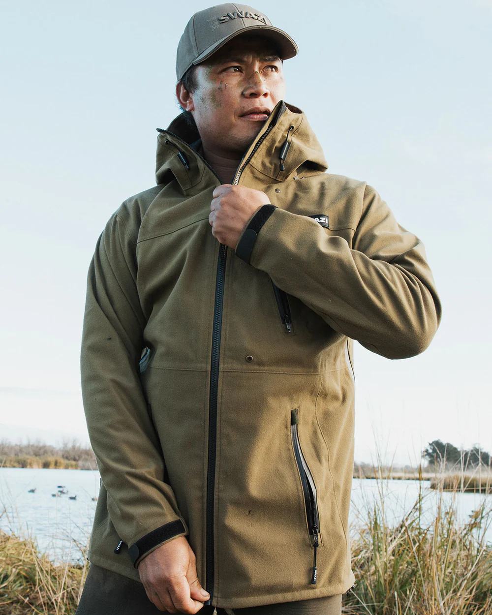 Tussock Green coloured Swazi The Ibex Jacket on sky background