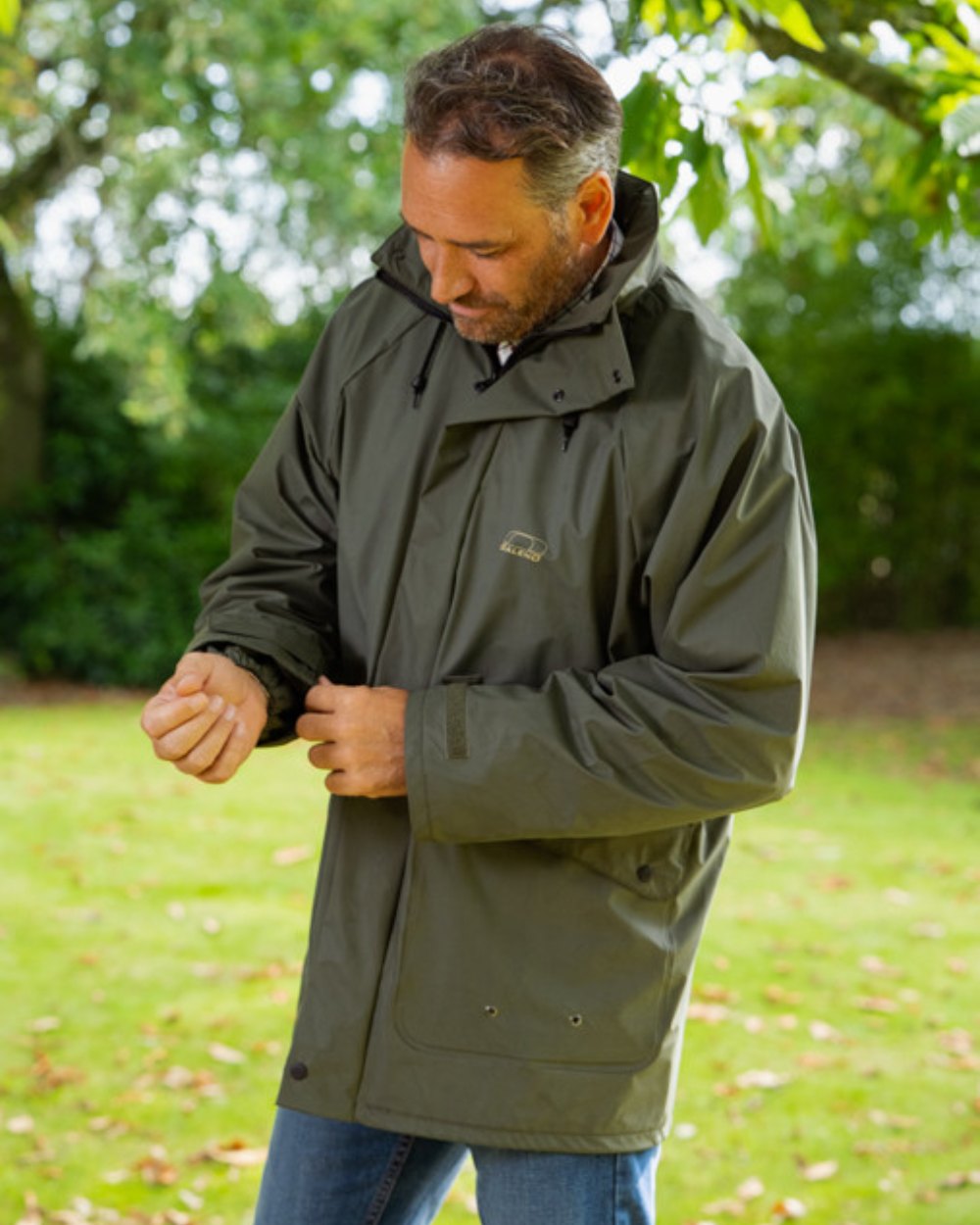 Khaki Coloured Baleno Arras Rain Jacket On A Park Background