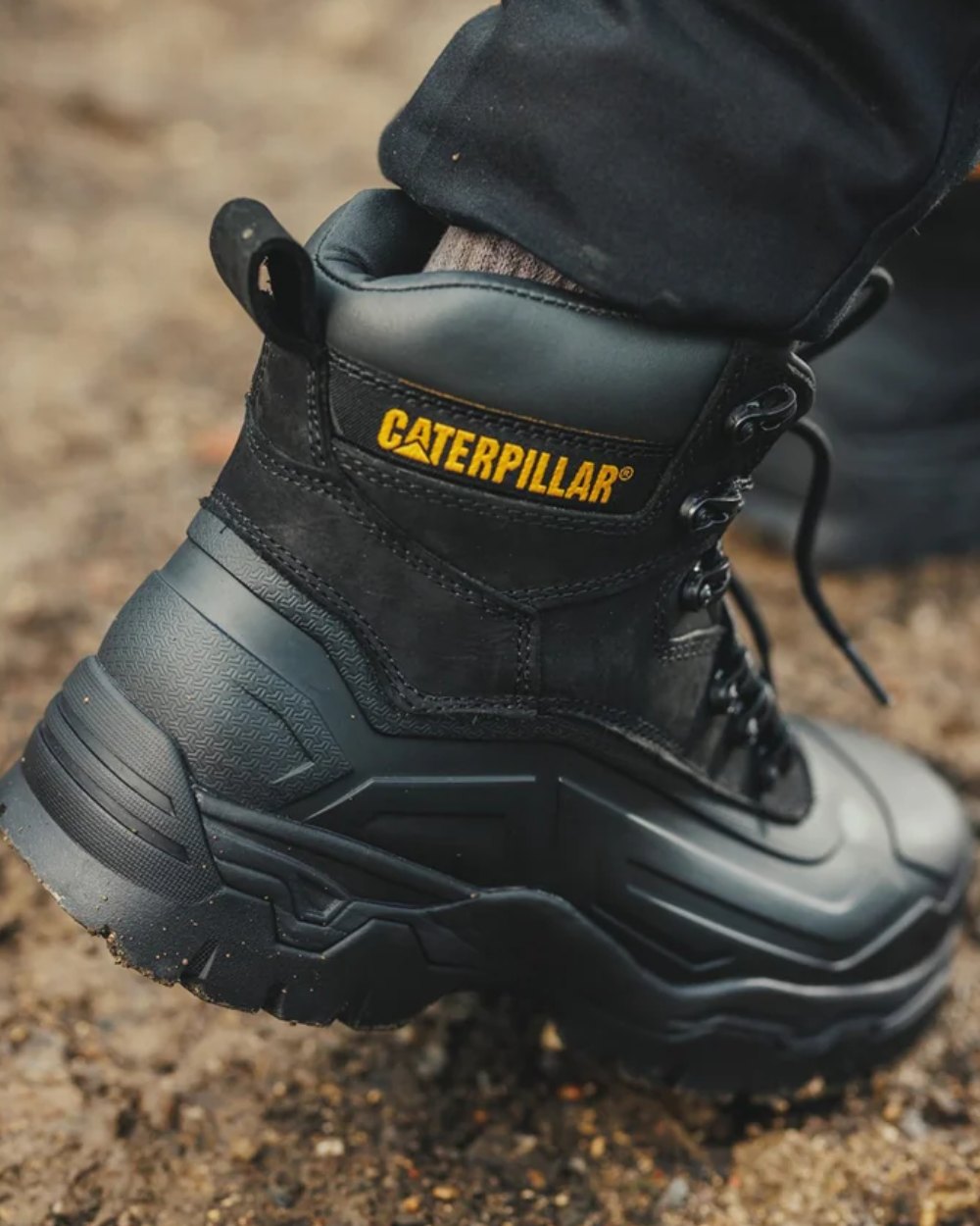 Black Coloured Caterpillar Typhoon SBH Safety Boot On A Street Background