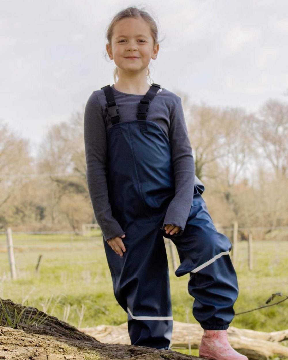 Navy Coloured Fort Childrens Splashflex Bib and Brace On A Field Background
