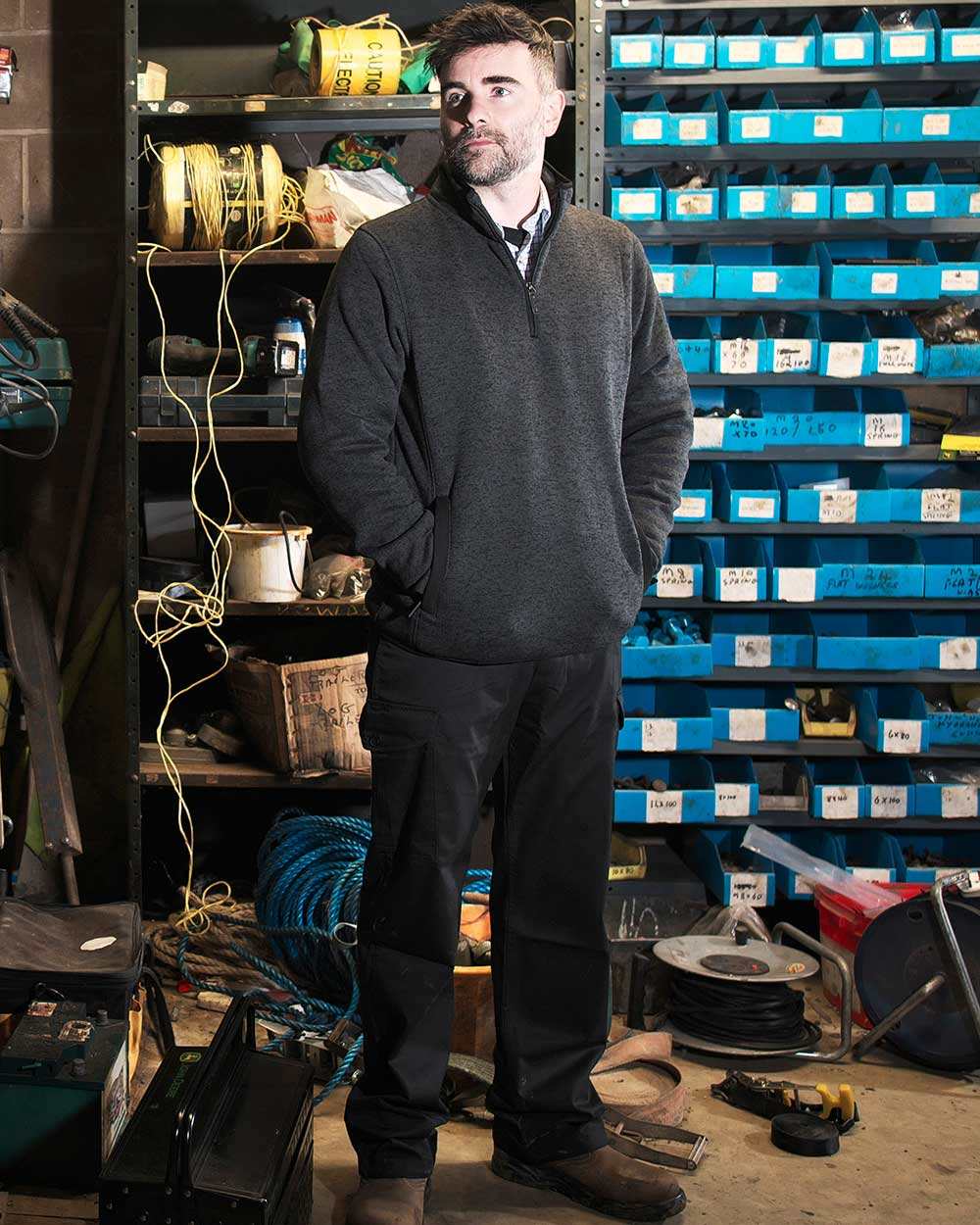 Black Coloured Fort Combat Trousers On A Factory Background