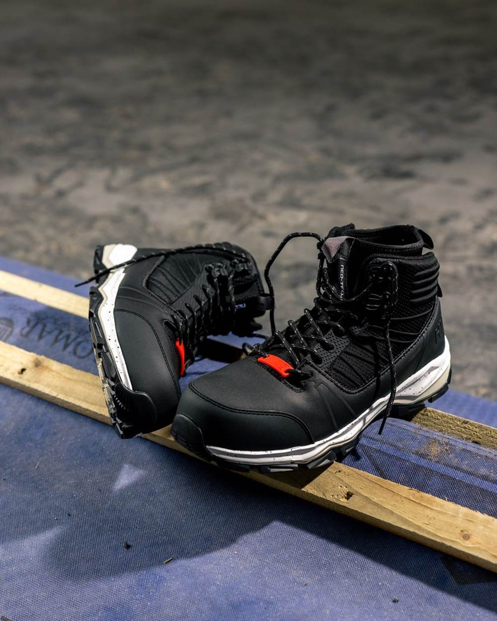 Black Coloured Hard Yakka Mens Neo 2.0 PR Hybrid Side Zip Safety Boots on Indoor Background