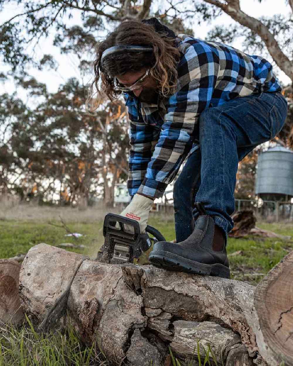 Brown Coloured Hard Yakka Outback Steel Toe Safety Dealer Boots on Outdoor Background