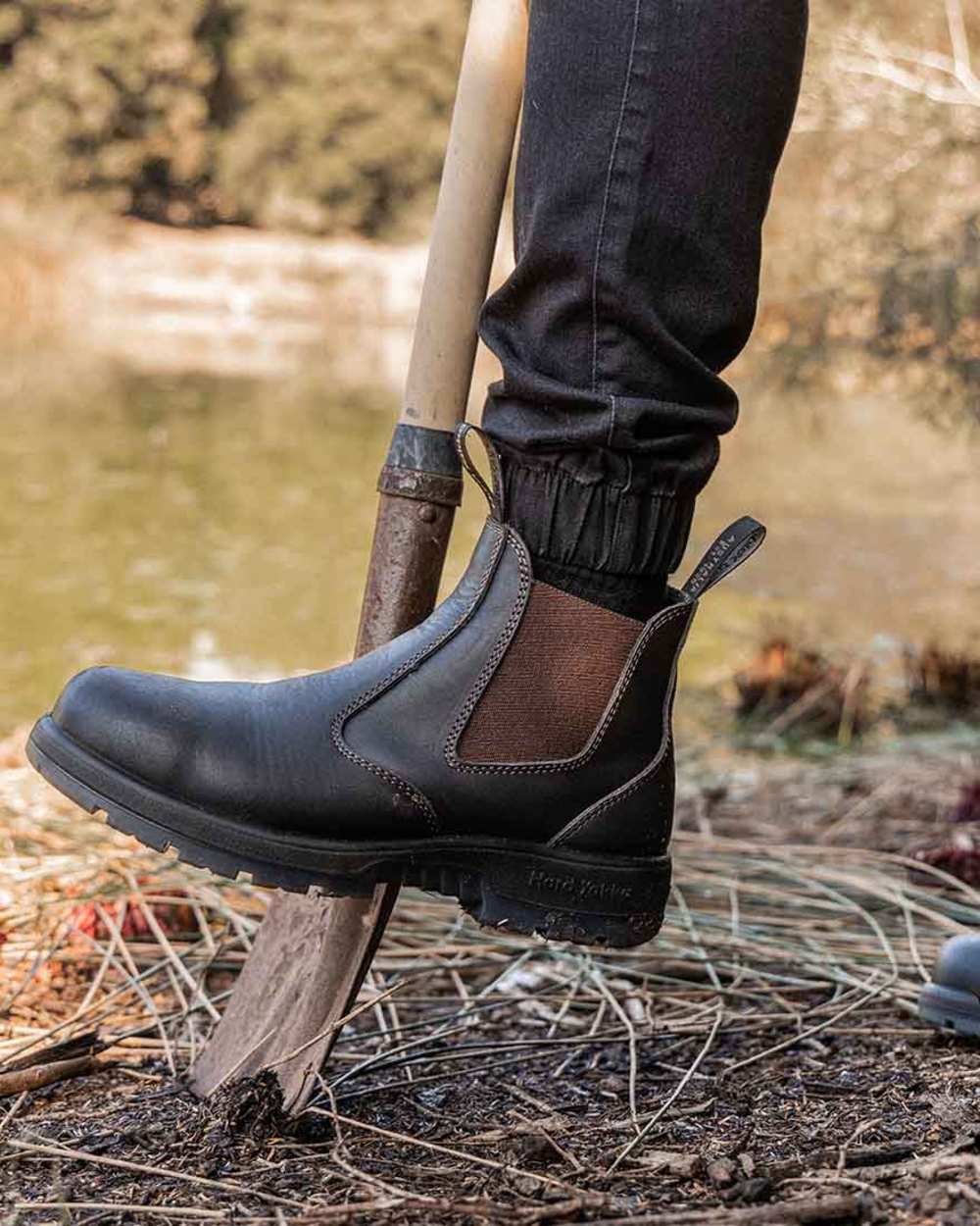Brown Coloured Hard Yakka Outback Steel Toe Safety Dealer Boots on Outdoor Background