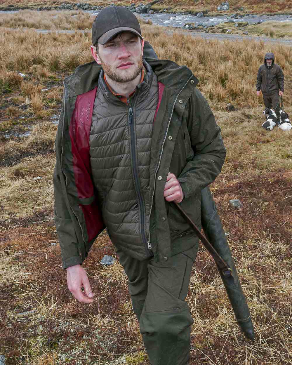 Fen Green Coloured Hoggs of Fife Culloden Waterproof Field Jacket on land background