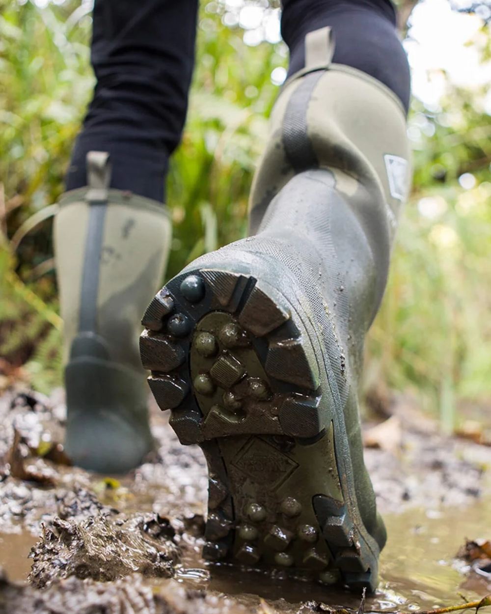 Moss Coloured Muck Boots Derwent II Wellingtons On A Forest Background
