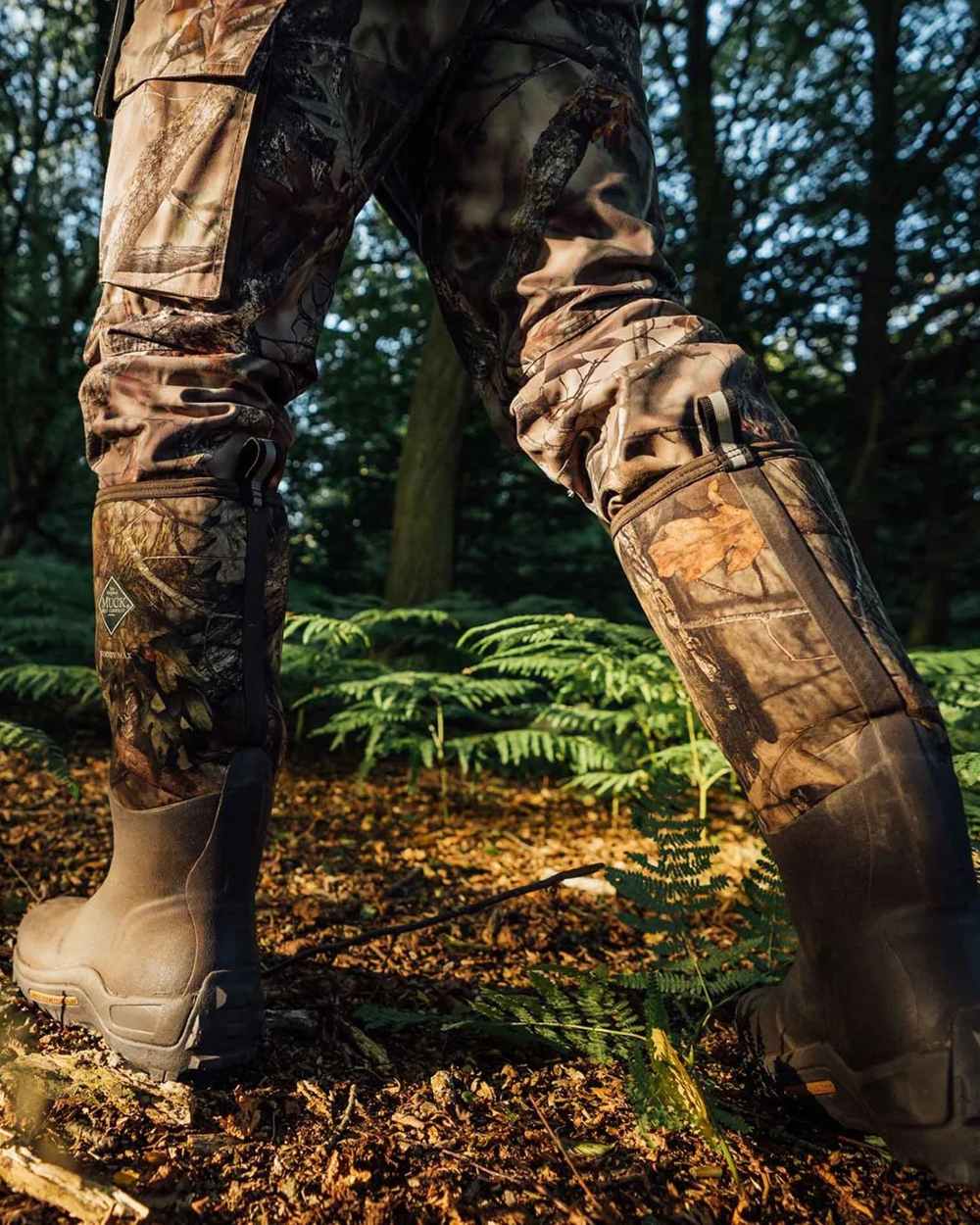 Mossy Oak Infinity Print Coloured Muck Boots Woody Max Tall Wellingtons On A Forest Background