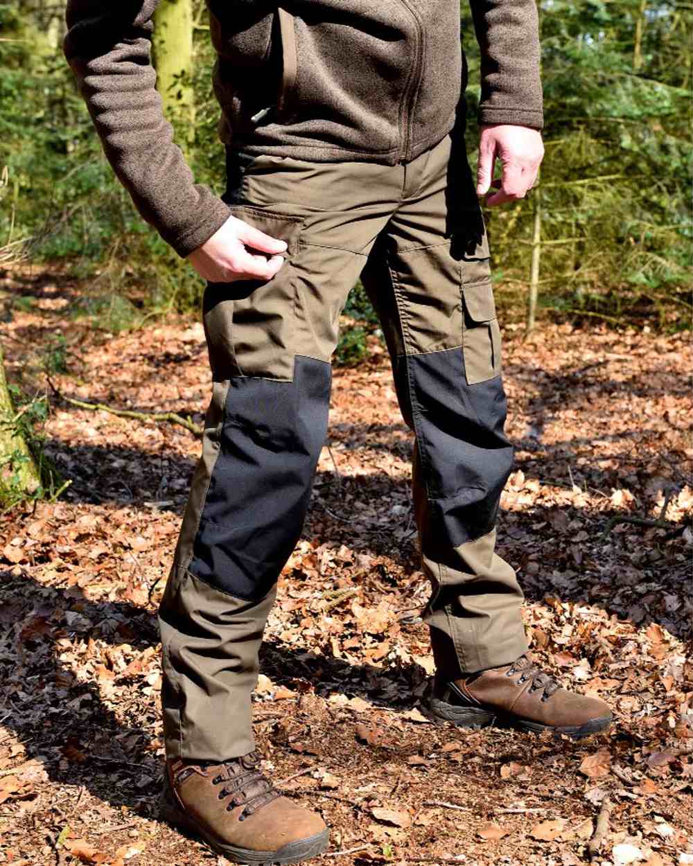 Green/Black coloured Rovince Mens Duofit Trousers on forest background