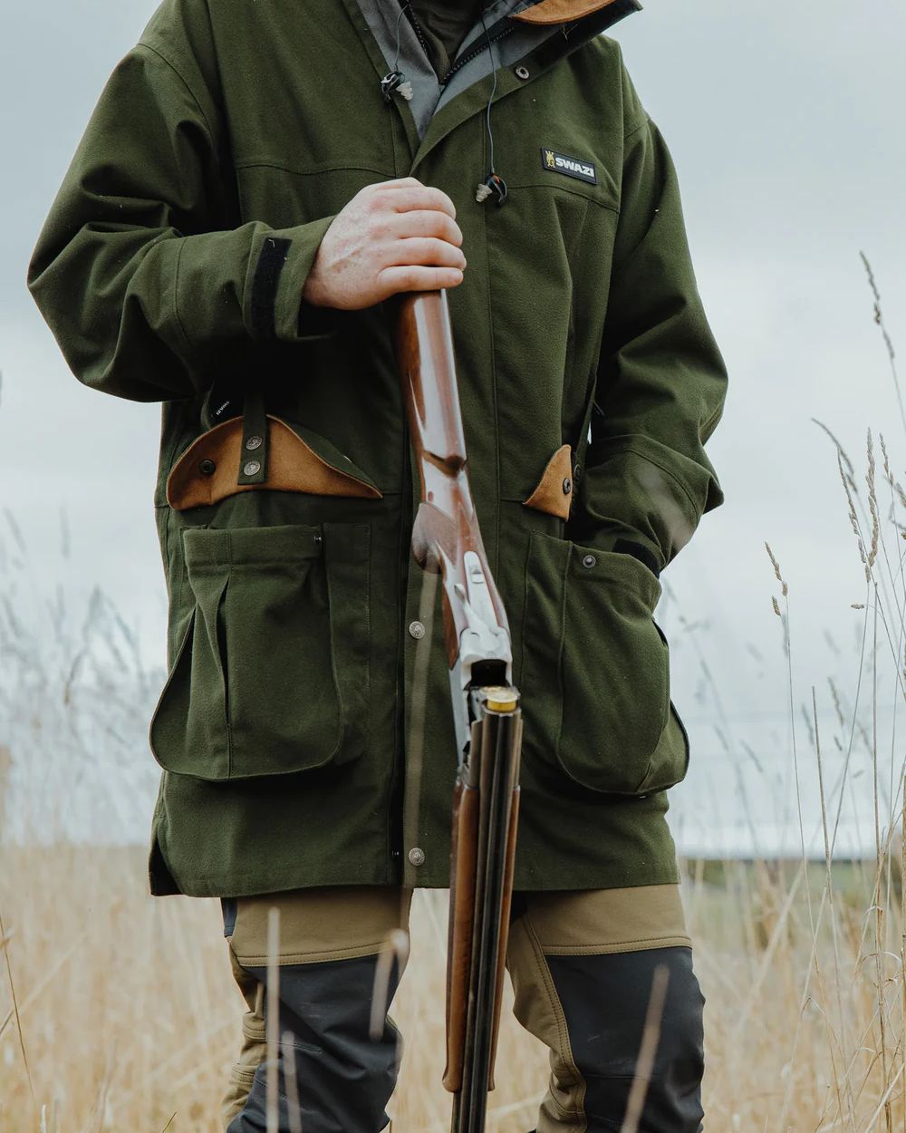 Olive Coloured Swazi Wapiti Xp Jacket On A Forest Background