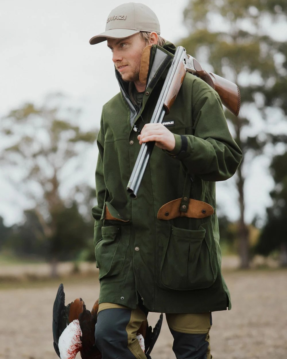 Olive Coloured Swazi Wapiti Xp Jacket On A Forest Background