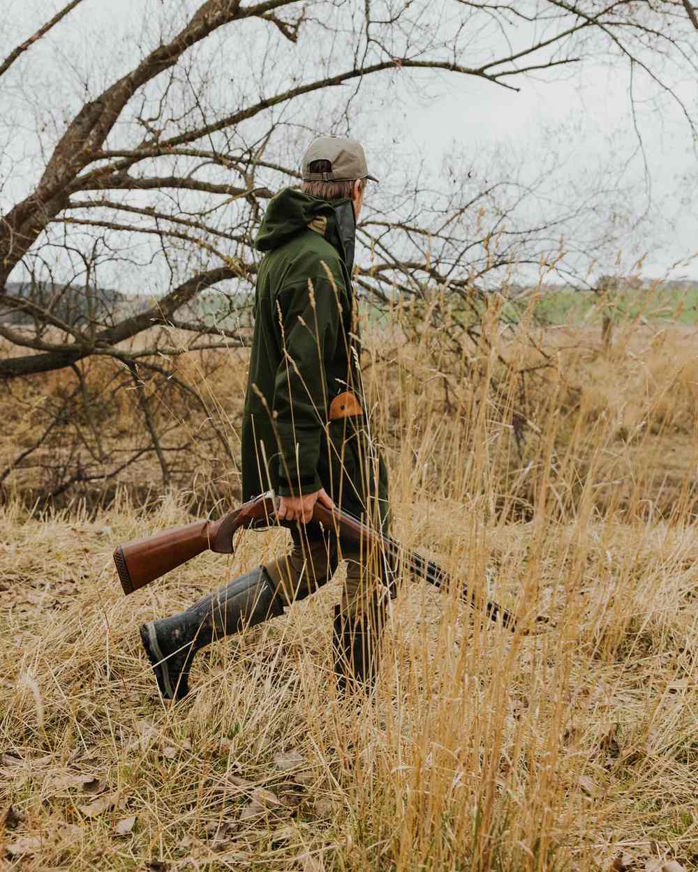 Olive Coloured Swazi Wapiti Xp Jacket On A Forest Background