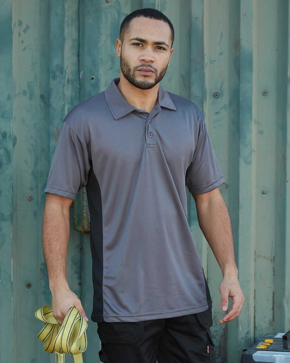 Grey Coloured TuffStuff Elite Polo Shirt On A Teen Sheet Background