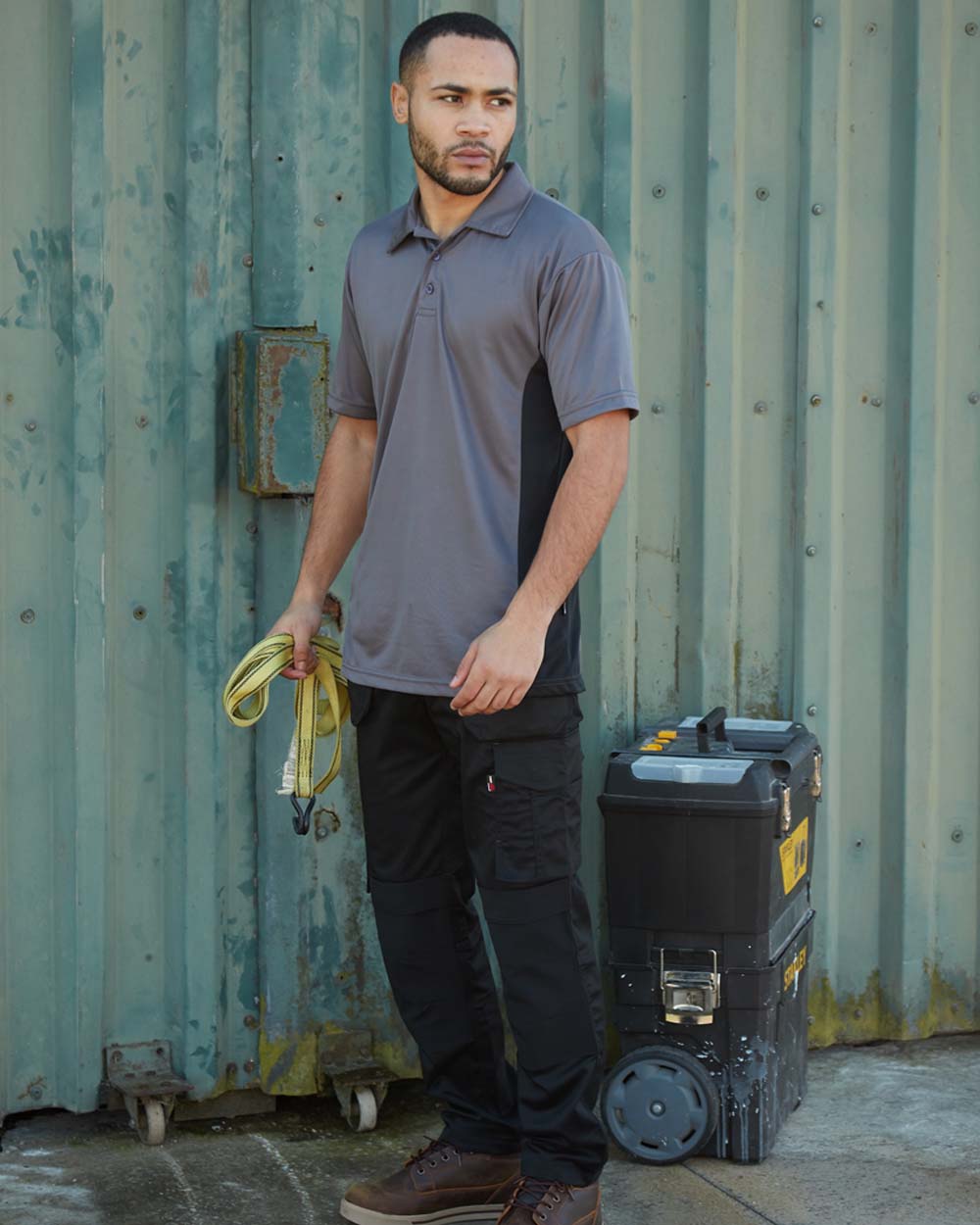 Black coloured TuffStuff ProFlex Work Trousers on Shed Door background
