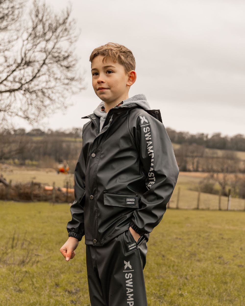 Navy Coloured Xpert Childrens Swampmaster Stormgear Waterproof Jacket on Outdoor Background