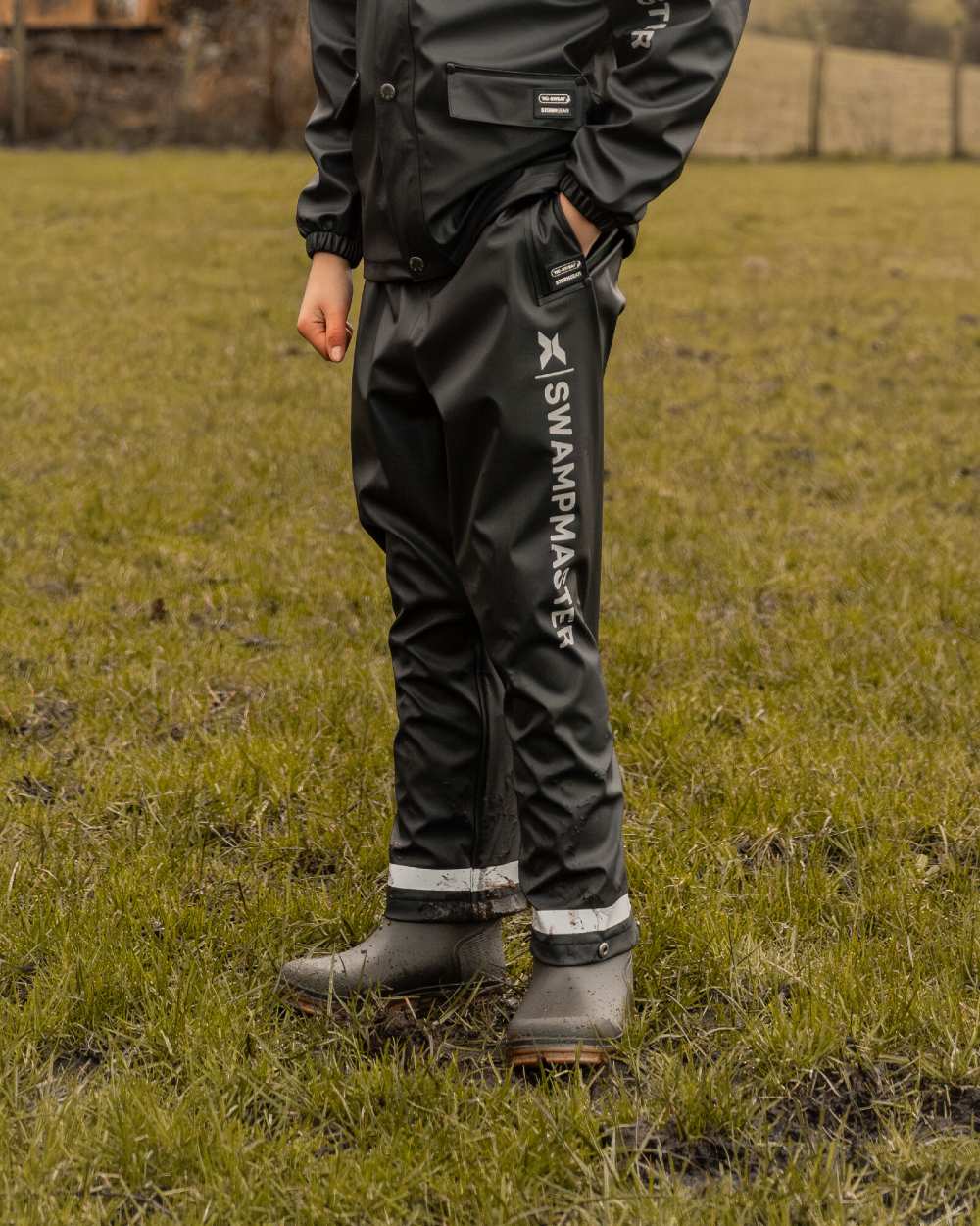 Navy Coloured Xpert Boys Swampmaster No-Sweat Stormgear Junior Waterproof Trousers on Outdoor Background