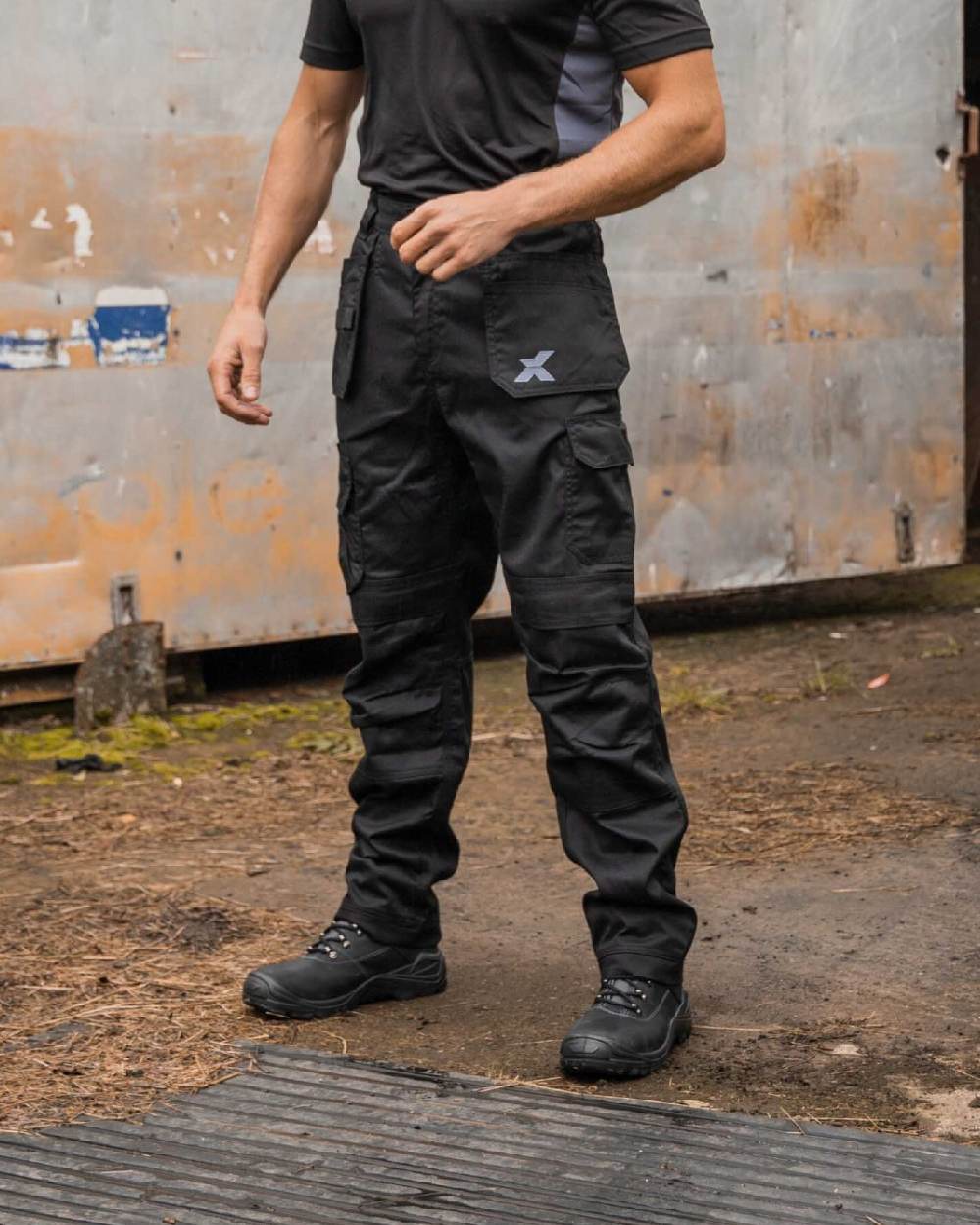 Black Coloured Xpert Mens Core Work Trousers on Outdoor Background