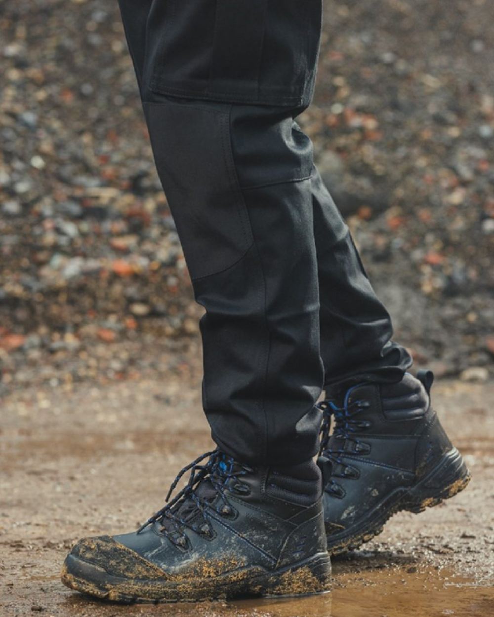 Black coloured Amblers Safety AS308C Waterproof Safety Boots on mud background