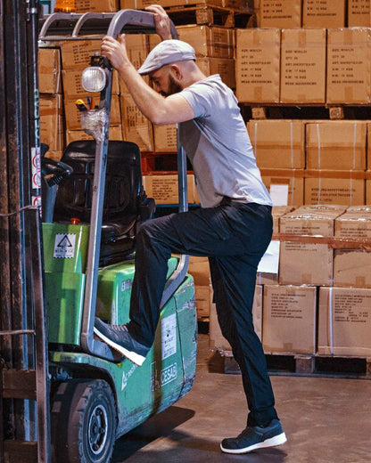 Black Coloured Apache Mens Barkerville Cargo Trousers on warehouse background 