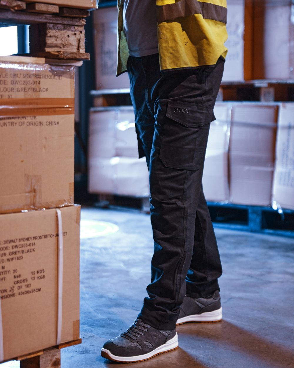 Black Coloured Apache Mens Barkerville Cargo Trousers on warehouse background 