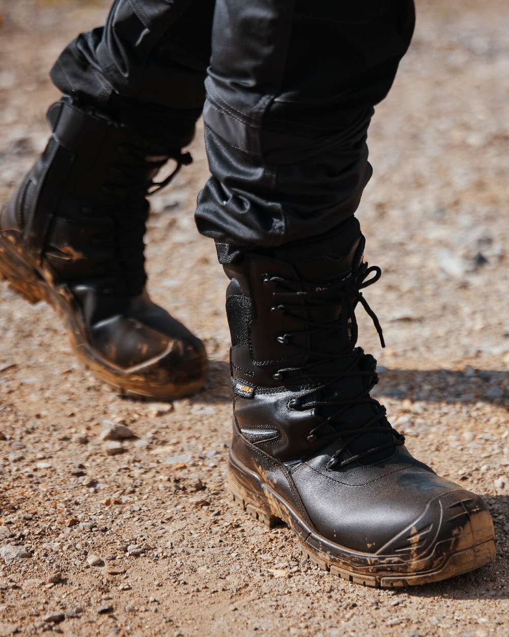 Black Coloured Apache Mens Combat High Leg Waterproof Safety Boots on outdoor background 
