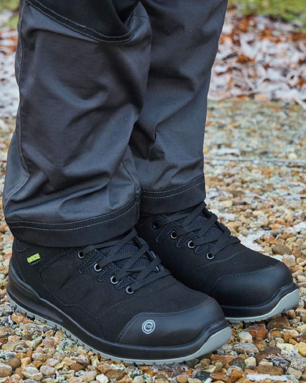 Black Coloured Apache Mens S3 Recycled Suede Safety Trainers on outdoor background 