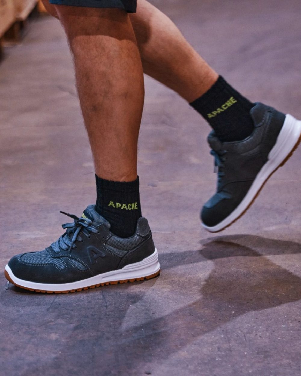 Charcoal Grey Coloured Apache Mens Winnipeg Suede Safety Trainer Shoes on warehouse background 