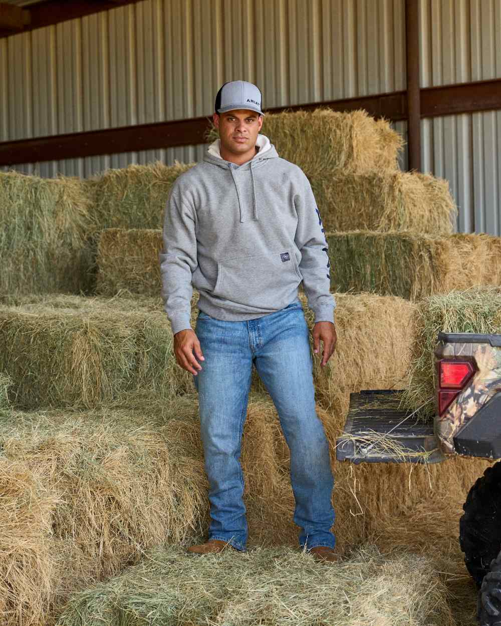 Heather Grey Deep Ultramarine Coloured Ariat Mens Rebar Graphic Hoodie on outdoor background 