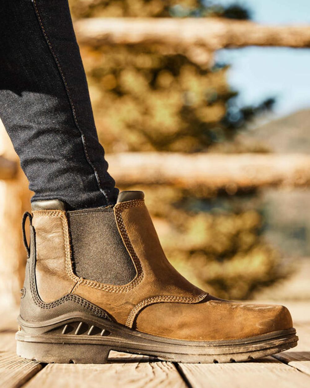 Antique Brown coloured Ariat Womens Barnyard Twin Gore II Waterproof Boot on outdoor background 