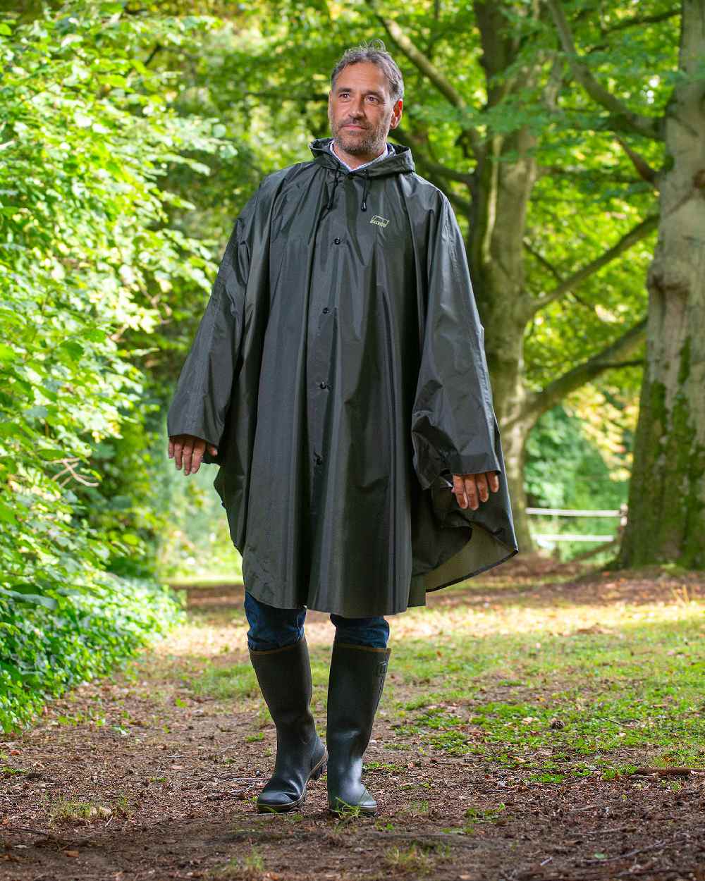 Khaki Coloured Baleno Tornado Nylide Rain Poncho on forest background 