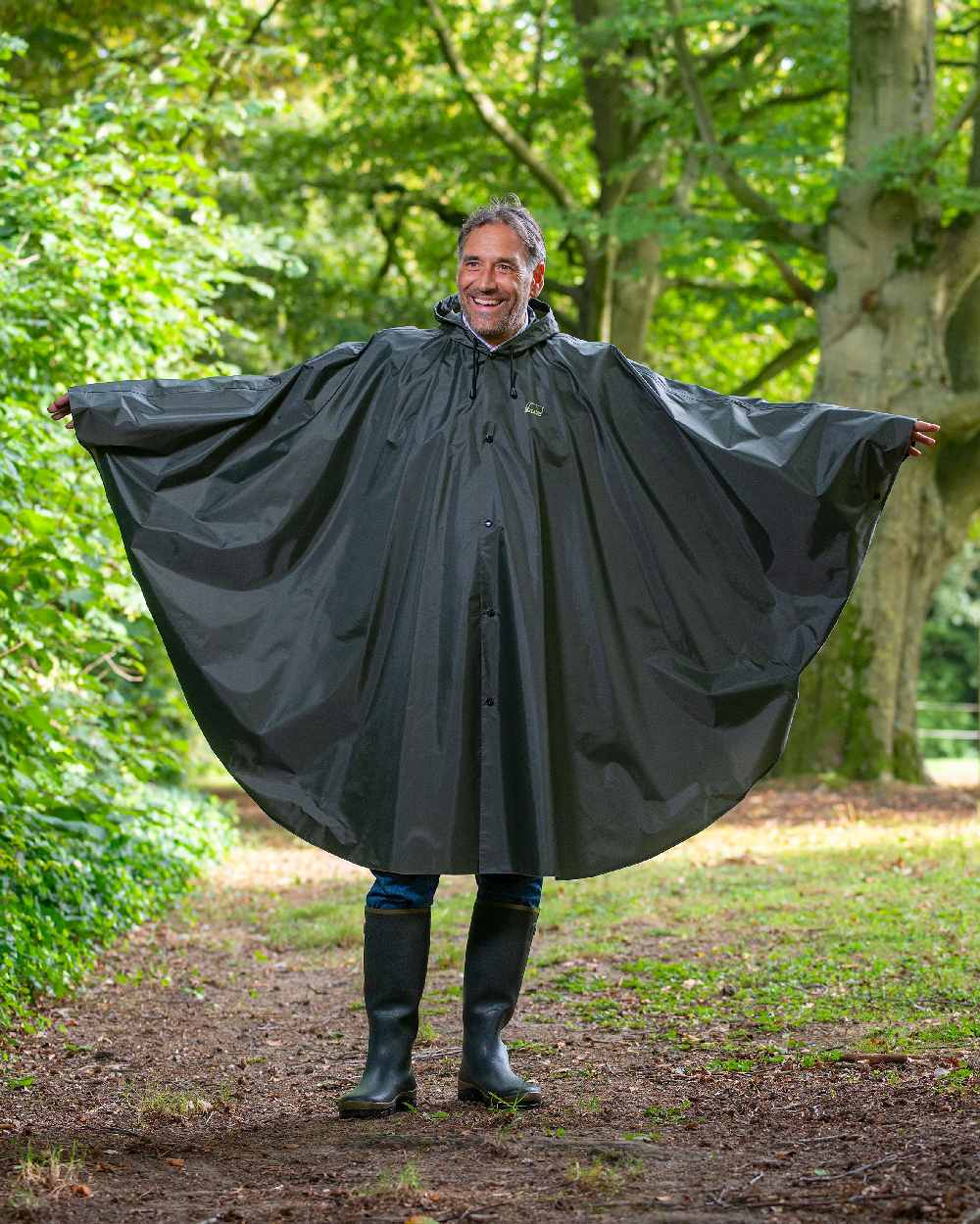 Khaki Coloured Baleno Tornado Nylide Rain Poncho on forest background 