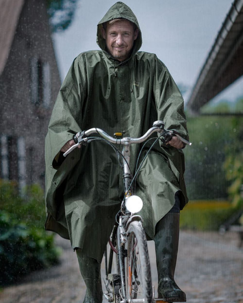 Khaki Coloured Baleno Tornado Nylide Rain Poncho on street background 