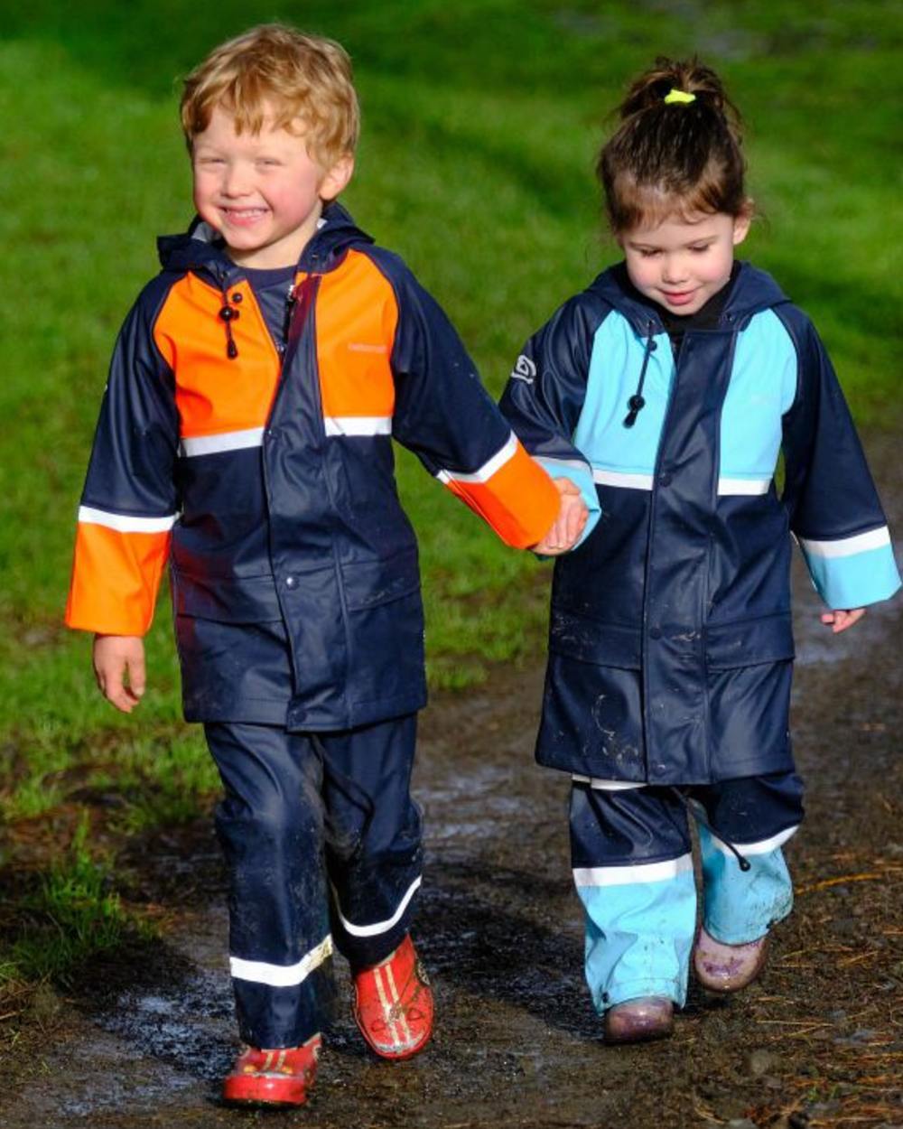 Navy Pale Blue coloured Betacraft Childrens Tuffbak Waterproof Parka on grassy background 