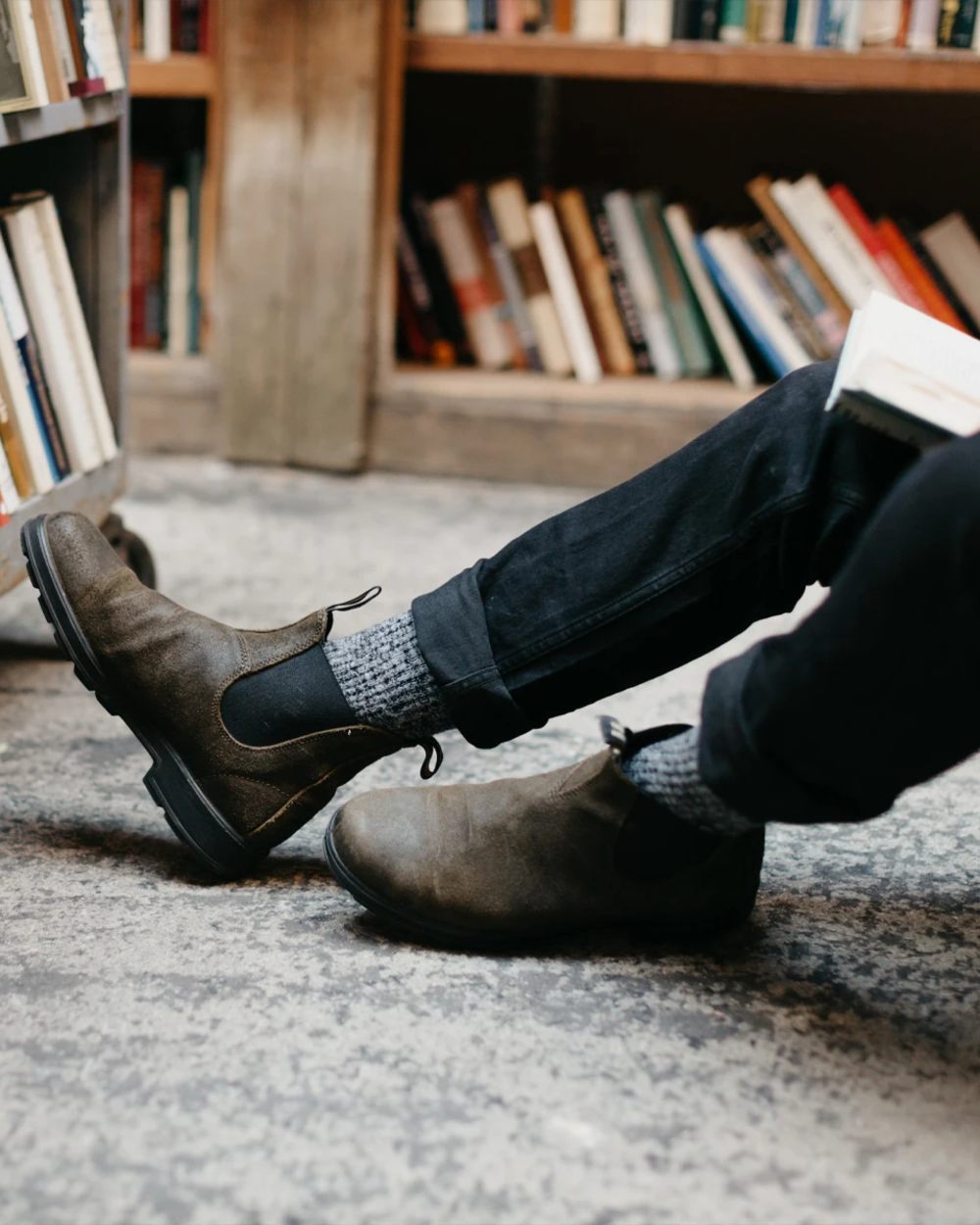 Dark Olive coloured Blundstone 1615 Classic Waxed Suede Chelsea Boots on library background 