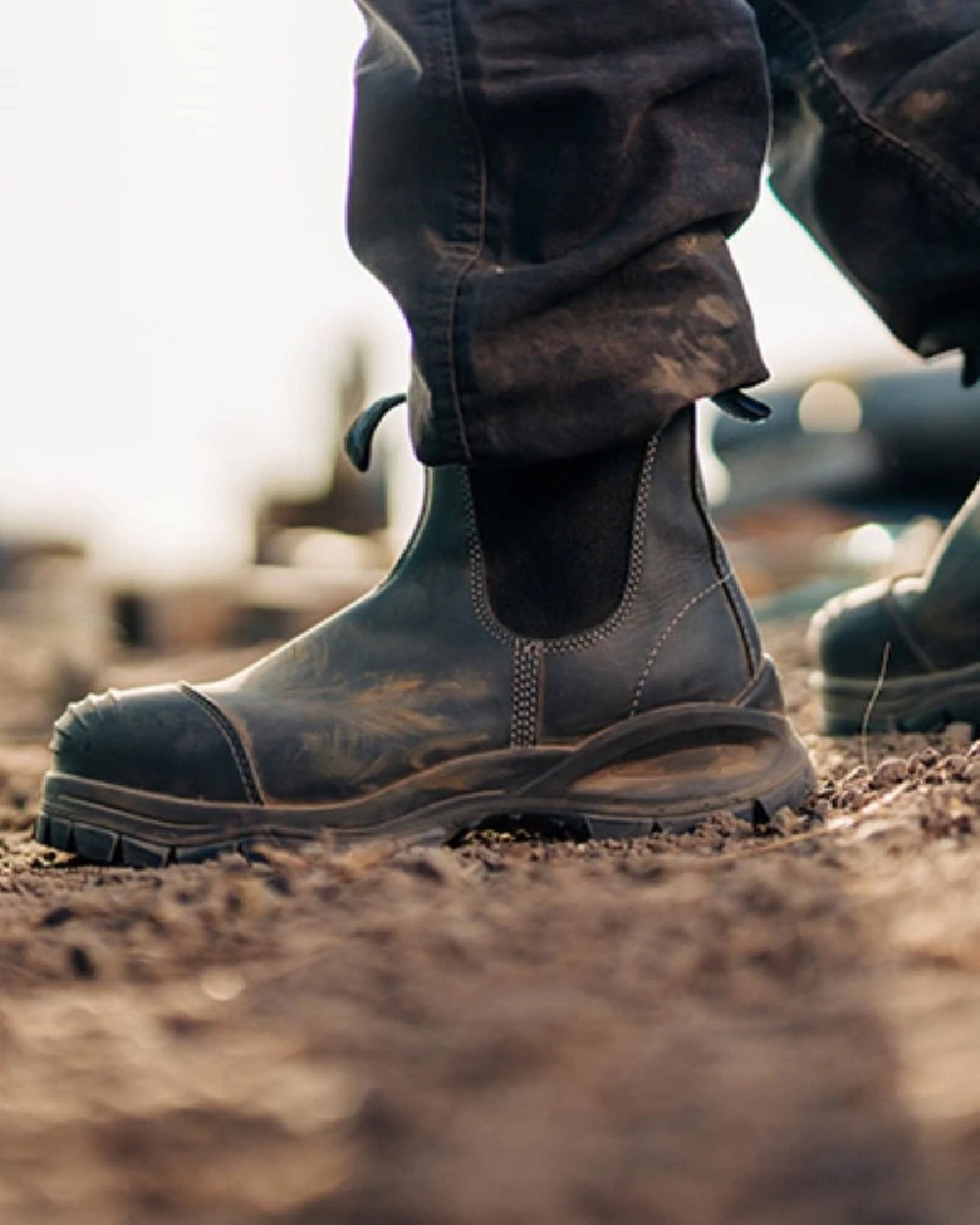 Black coloured Blundstone 910 Black Platinum Safety Boots on soil background 