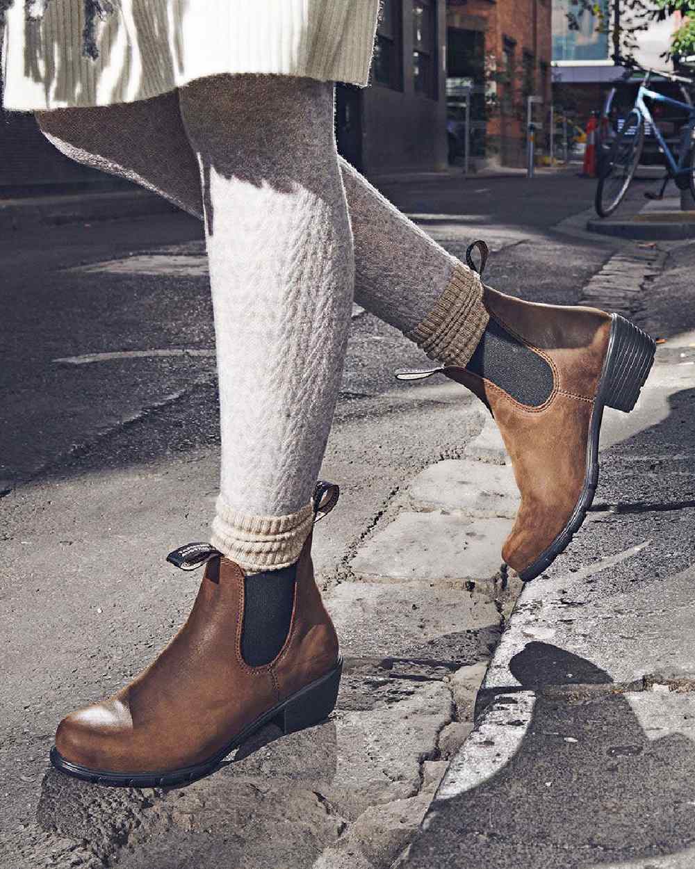 Antique Brown coloured Blundstone Womens 1673 Chelsea Boots on street background 