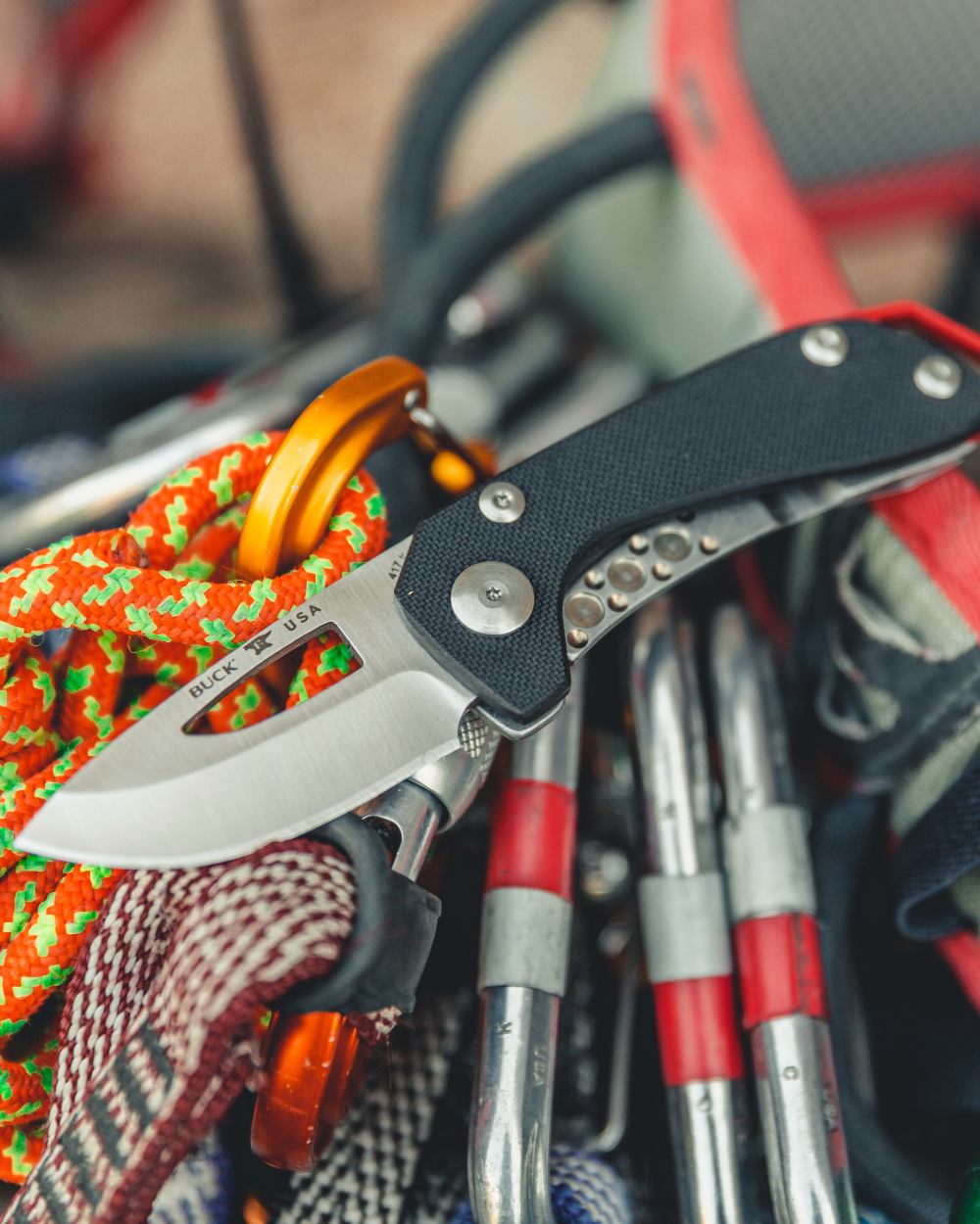 Black coloured Buck Budgie Knife on blurry background 