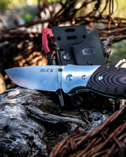 Buck Folding Selkirk Knife on forest background