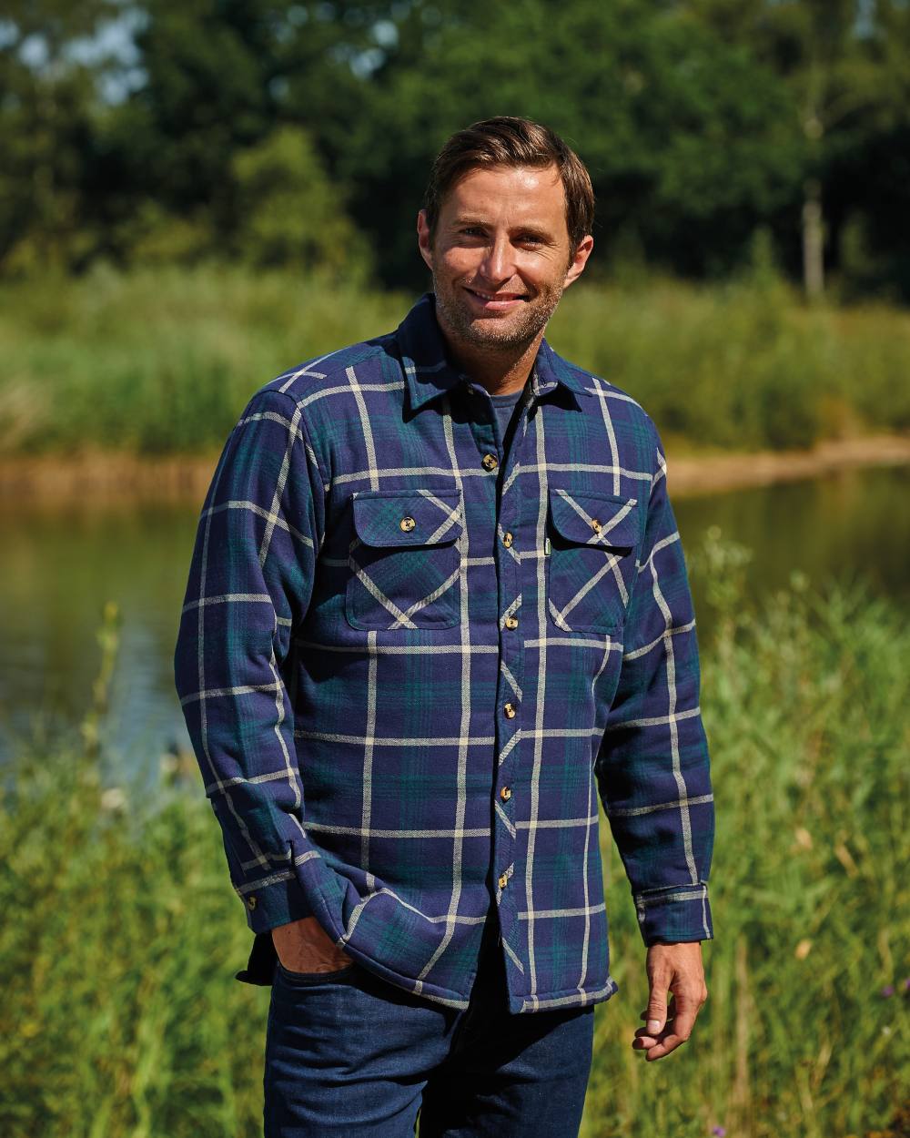 Blue coloured Champion Totnes Quilted Padded Shirt on forest background 