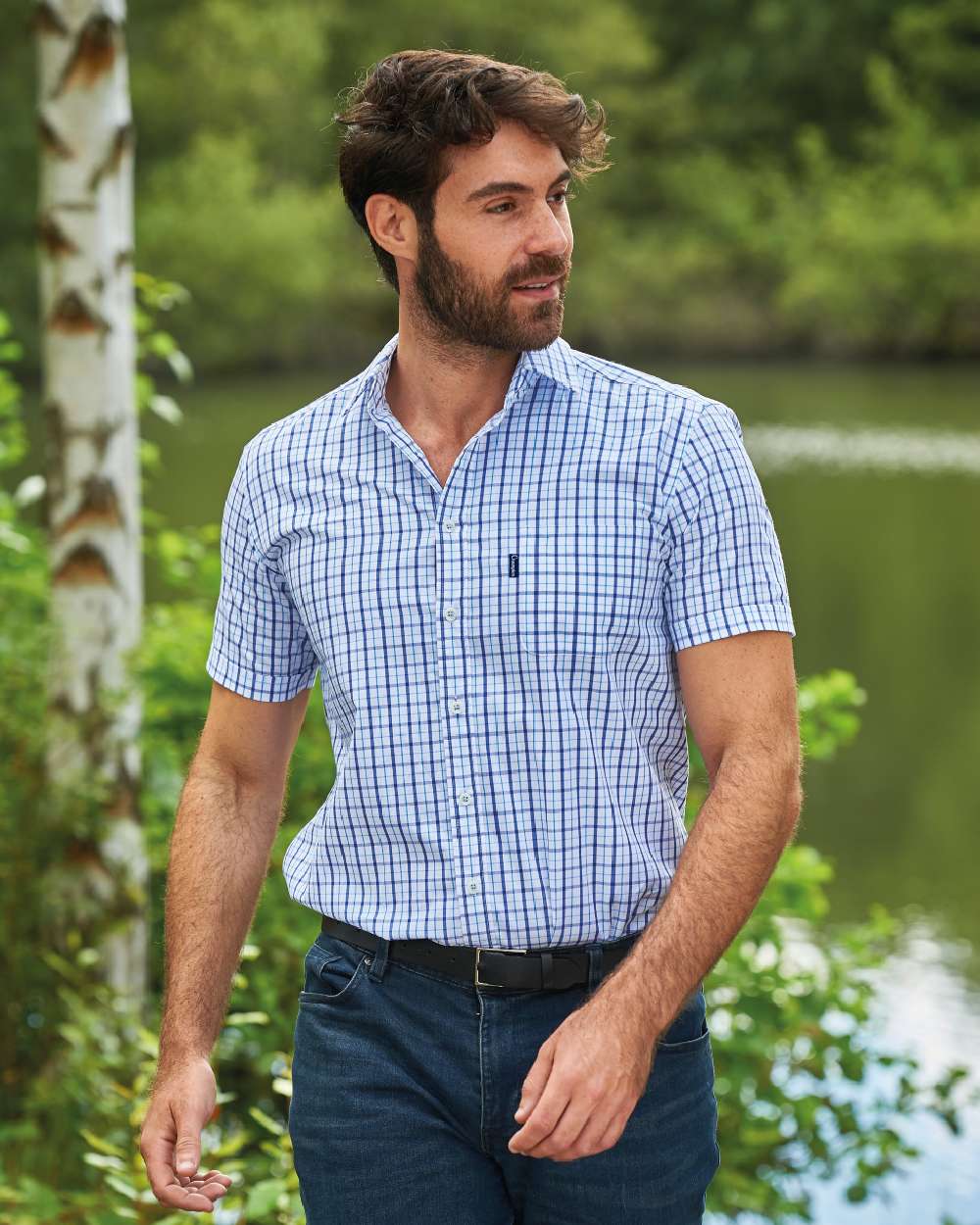 Blue coloured Champion Whitstable Short Sleeve Shirt on pond background 