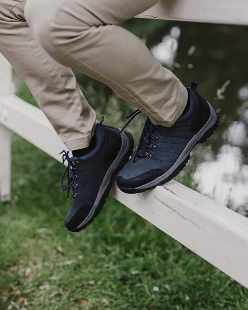 Navy coloured Cotswold Toddington Hiking Shoes on grass background 