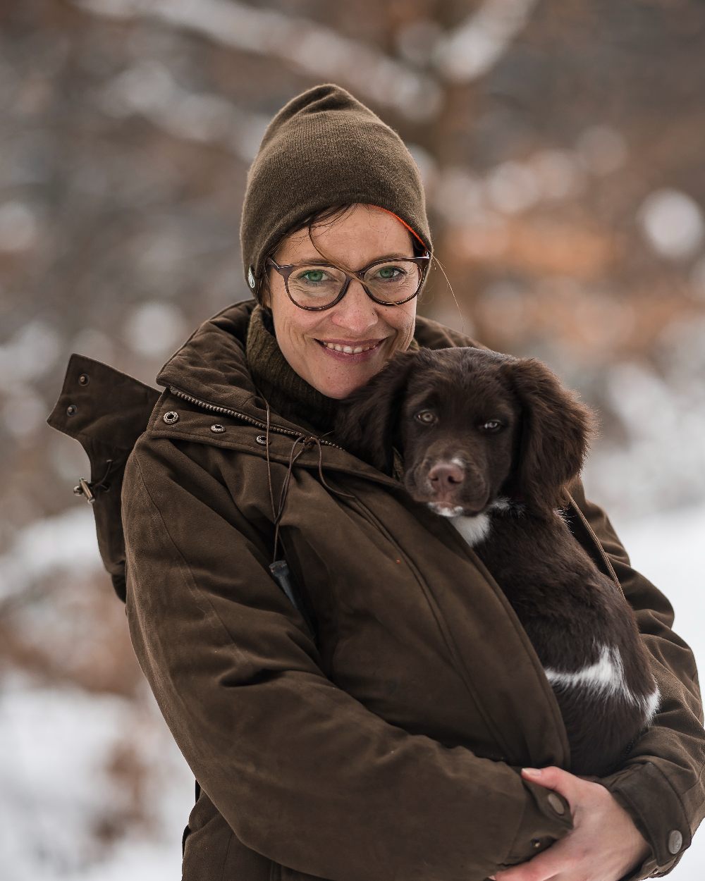 Orange Green coloured Deerhunter Cumberland Reversible Beanie on blurry background